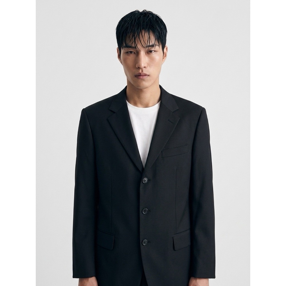 breasted suit jacket in solid black.